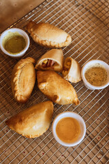 A table with empanadas and sauces