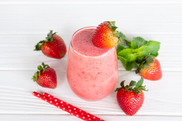 Strawberry yogurt fruit juice smoothie pink colorful fruit juice milkshake blend beverage healthy high protein the taste yummy In glass drink episode morning on white wood background.