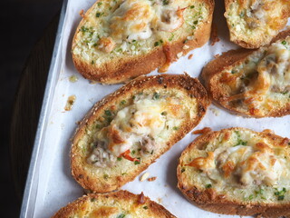 slice of bread toasted with cheese and shrimp topping