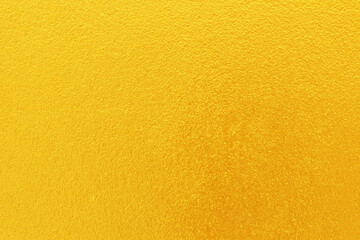Gold or yellow paint on cement wall texture  background.
