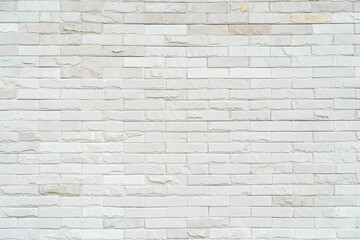 Cream and white brick wall texture background with Sunlight. Brickwork or stonework flooring interior rock old pattern clean concrete grid uneven bricks design stack.