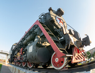 Old steam locomotive L-112 on a pedestal in the city of Prokopyevsk