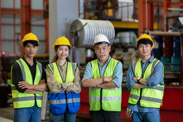 Group of various nationalities engineer professional successful team corporate workers standing in factory. teamwork technician inspector manufacturing industry workplace.