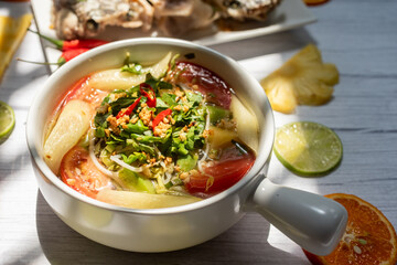 Vietnamese family food. Sour soup bowl of snakehead fish is rich in Vietnamese culinary identity