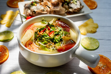 Vietnamese family food. Sour soup bowl of snakehead fish is rich in Vietnamese culinary identity