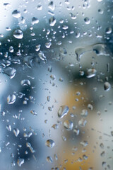 Raindrops falling on glass, abstract blurs - monsoon stock image of Kolkata (formerly Calcutta) city , West Bengal, India