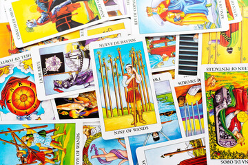 Tarot cards, Rider Waite tarot cards,the nine of wands card in the foreground. - obrazy, fototapety, plakaty