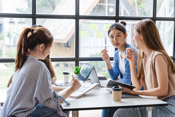 Young creative team work four colleagues ladies discussing ideas in boardroom. Group of asian female people during start up business meeting in office.