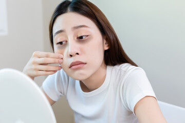 Asian young female stress looking mirror check have dark eye circles on face from staying up sleepy...