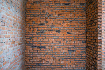 A room with bare brick walls. Brick wall at construction site