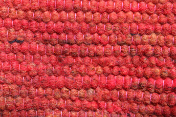 Fototapeta na wymiar Shades of red wool yarn cloth abstract background. Surface of fabric texture in red, crimson, reddish yellow and orange color. 