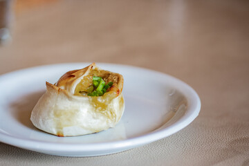 A typical baked Argentinian empanadas (similar to pie) with quinoa, cheese and green onion filling. Vegetarian food from Catamarca, Argentina.