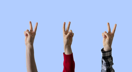 large group of people rise hands and show peace sign, no war concept