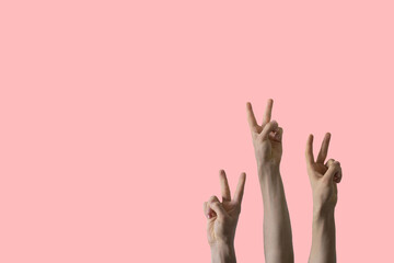 large group of people rise hands and show peace sign, no war concept