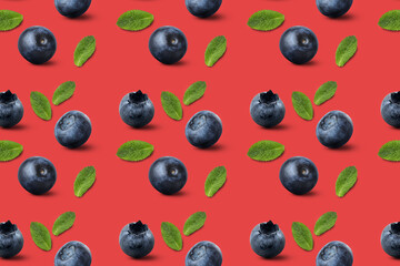 Many ripe blueberries and mint leaves on red background. Pattern for design