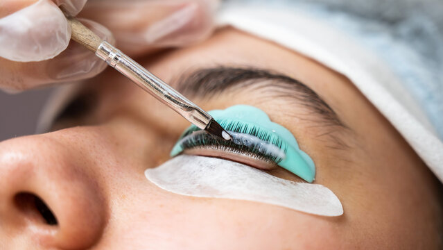 Close-up portrait of a woman on eyelash lamination procedure. 
