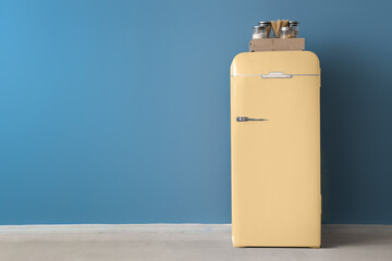 Retro fridge near blue wall