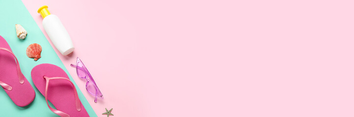 Bottle of sunscreen and beach accessories on color background with space for text