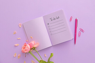 Notebook with blank to-do list, flowers and stationery on lilac background