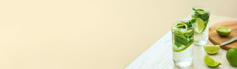 Jars of fresh mojito on light background with space for text