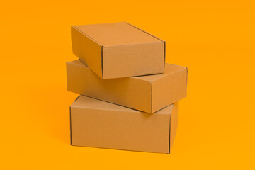 Fototapeta premium set of cardboard boxes on yellow background, delivery or moving concept