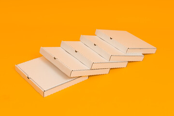 pizza boxes on yellow background