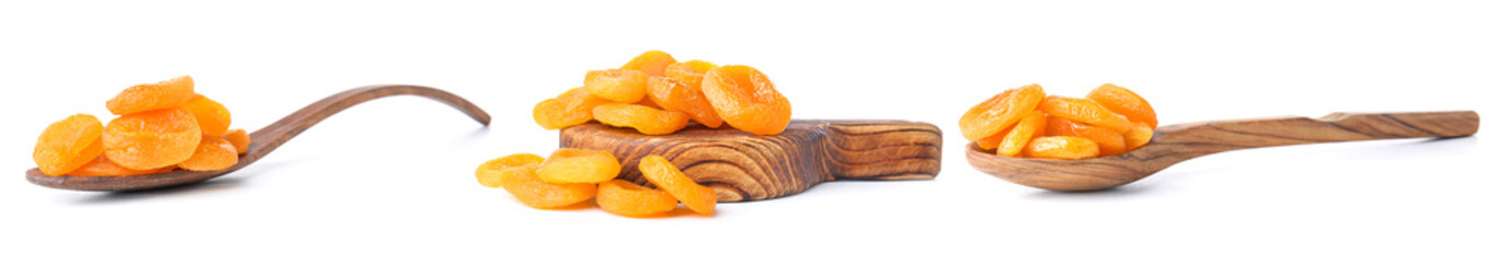 Spoons and board with tasty dried apricots on white background