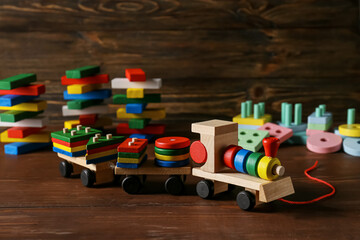 Toy train with building blocks on dark wooden background