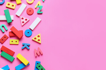 Children building blocks with letters on pink background
