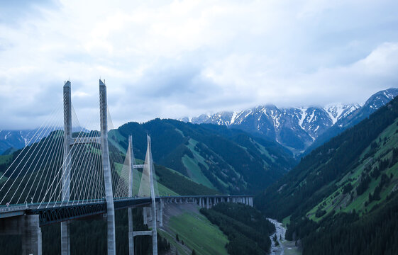 Fruit valley bridge with remote snow mountains