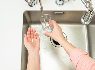 woman taking medication at home for menstrual pain