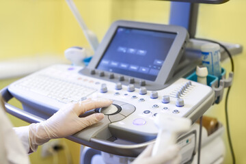 Doctor using ultrasound machine in clinic