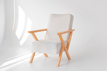Fototapeta na wymiar Stylish wooden armchair in modern photo studio