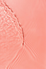 Texture of water with ripples on pink background, closeup