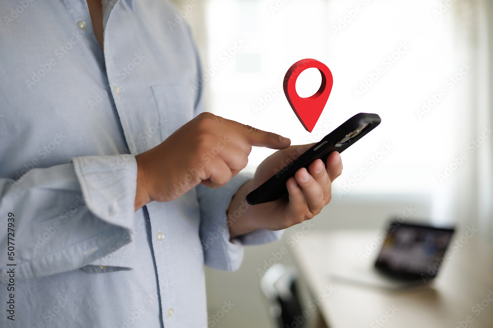 Poster hand using a smartphone holding gps map to route destination network connection location street map 