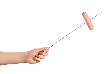 Female hand holding wooden skewer with sausage on white background