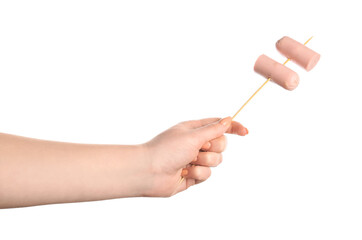 Female hand holding wooden skewer with sausage on white background