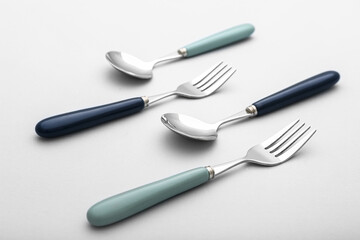 Set of stainless steel cutlery on light background