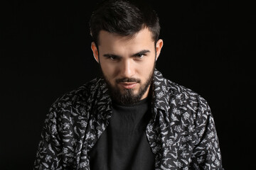 Portrait of bearded man on dark background