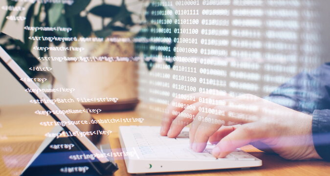 Businessman working with laptop computer on wooden desk in modern office . Programmers and cyber security technologies design.