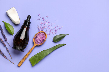 Bottle of natural serum, spoon with sea salt, plant leaves, lavender and coconut on violet...