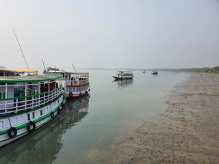 Fototapeta na wymiar Sundarban, West Bengal, India - December 27, 2021: Boats in river at sundarbans national park
