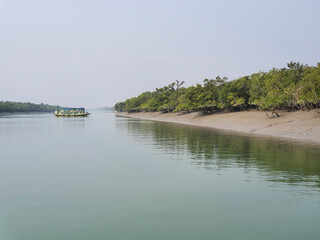 Sundarban, West Bengal, India - December 27, 2021: boat crossing the river at sundarbans national park
