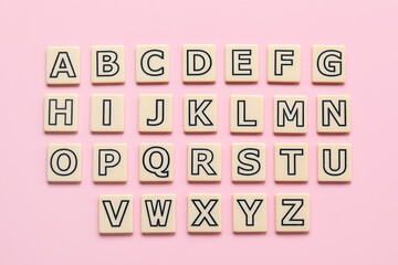 Different letters on pink background. Alphabet concept