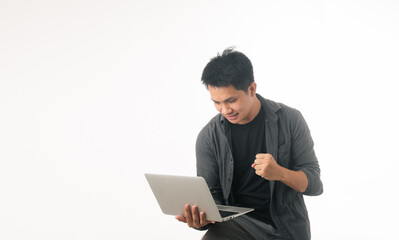 Image of a happy young delivery man standing with parcel post box isolated over white background.