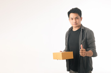 Image of a happy young delivery man standing with parcel post box isolated over white background.