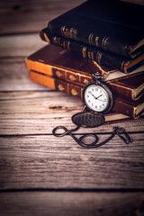 old pocket watch and books