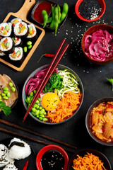 Assortment of Korean food on dark background.