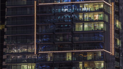Fototapeta na wymiar Flat night panorama of multicolor light in windows of multistory buildings aerial timelapse.