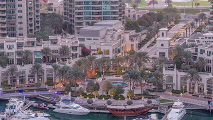 Picturesque fountain on Dubai Marina promenade aerial night to day timelapse